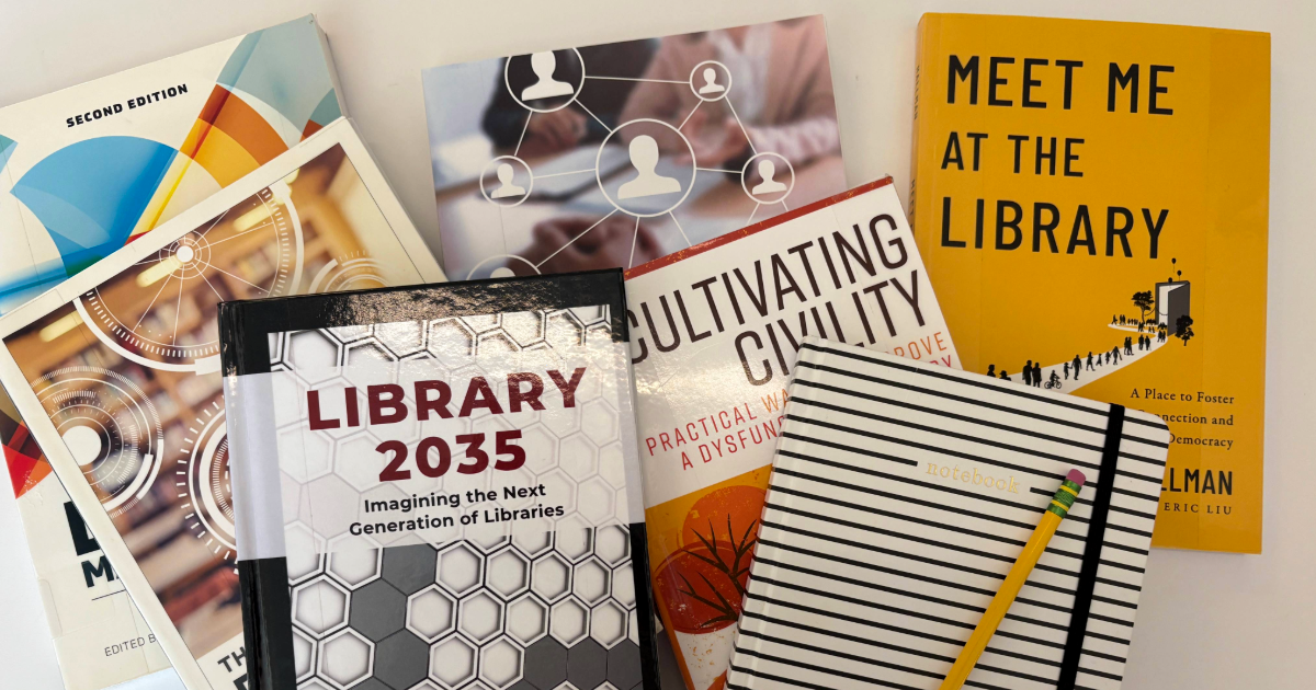 Titles from USL's Professional Development Collection laid out on a desk.