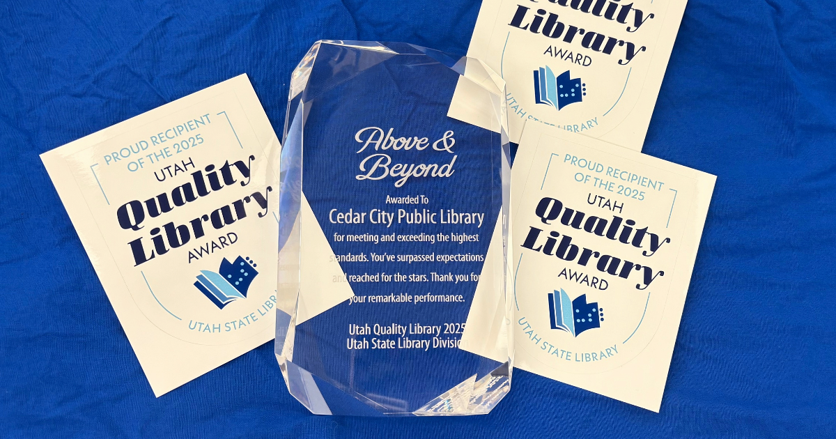 A Utah Quality Library rests on a blue background, surrounded by Utah Quality Library decals